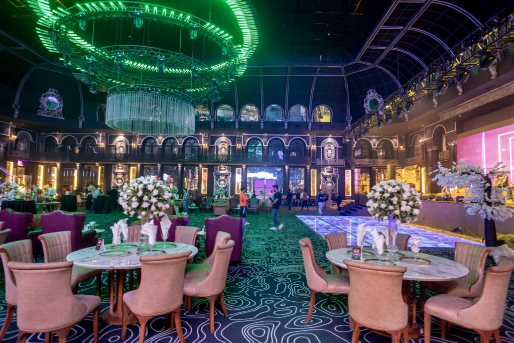 a fancy dining room with chandeliers and tables